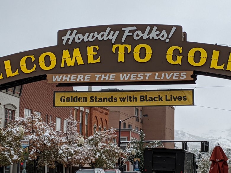 A banner reading “Golden Stands with Black Lives” hangs from the iconic “Welcome to Golden” sign over Washington Avenue in September 2020.